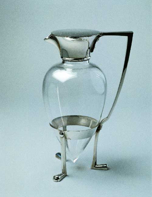 Decanter designed by Christopher Dresser. Manufactured by Hukin & 
        Heath Birmingham, England, 1879 Silver-plated metal (electroplate), glass. 
        Lent by Andrew McIntosh Patrick Photo: © 2001 Michael Whiteway