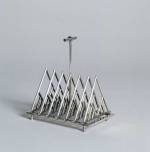 Toast rack designed by Christopher Dresser. Manufactured by James Dixon 
        & Sons Sheffield, England, ca. 1879 Silver-plated metal (electroplate). 
        From the Collection of Ellen and Bill Taubman. Photo: © 2001 Michael 
        Whiteway