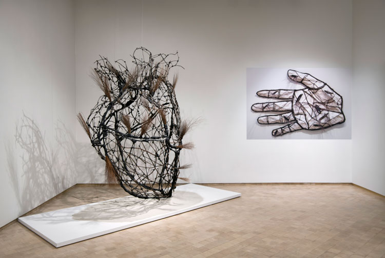 Juan Francisco Elso. Corazón de America (Heart of America), 1987-88. Twigs, wax, volcanic sand, iron and fabric. Courtesy of Museo Universitario Arte Contemporáneo, DiGAV-UNAM; La mano Creadora (The Hand of the Creator), 1988. Photographic reproduction of sculpture of amate paper, twigs, mirror, wax, volcanic sand, and fabric. Courtesy of Museo Nacional de Bellas Artes, Havana, Cuba.