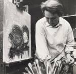 Audrey Walker. Joan Eardley at easel, looking downwards and holding paintbrushes. Photograph: John McKenzie. © Jane Walker.