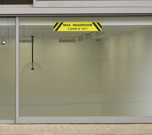 Ceal Floyer. Maximum Headroom, 2014/2018. Site specific custom printed aluminium sign, dimensions variable. © Ceal Floyer. Courtesy Lisson Gallery.