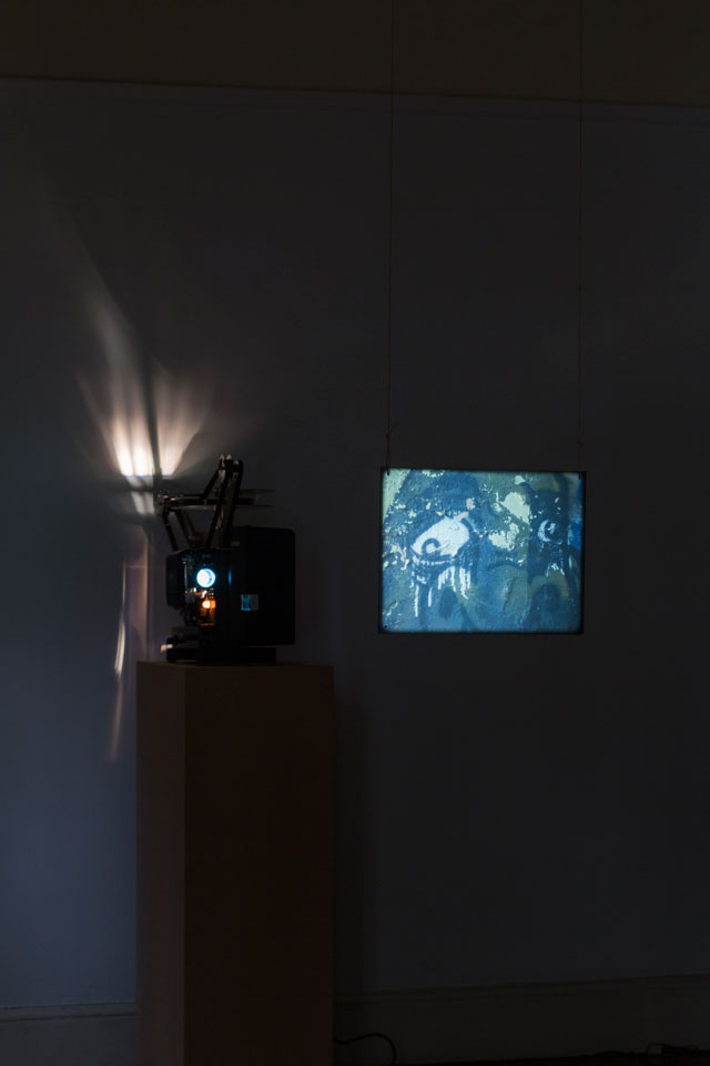 Louisa Fairclough, A Rose, 2017, 1 x 16mm film looped (colour, silent, 9 minutes) projected onto a suspended acrylic screen, 1 x performance for a field recording pressed onto dubplate vinyl (20 minutes). Installation view: A Song cycle for the Ruins of a Psychiatric Unit, Danielle Arnaud Gallery, 2017. Photograph by Oskar Proctor. Courtesy the artist and Danielle Arnaud.