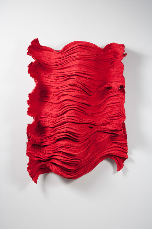 Hiroko Watanabe. <em>Aka no kodo</em> (Red Pulse), 1999. Cotton and metal fibre; hand weaving. 51 × 39 × 10 in. (129 × 98 × 25 cm). Photo: Mareo Suemasa.
