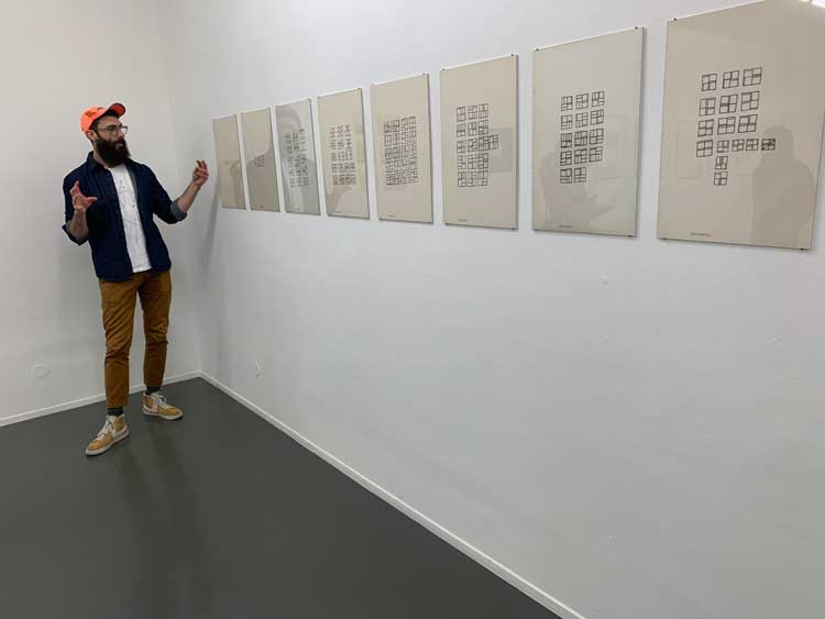 Concrete Experience. Co-curator Alex Balgiu beside Ana Hatherly’s Alfabeto estrutural (structural alphabet), 1967. Drawing on paper. Photo: Bronac Ferran.