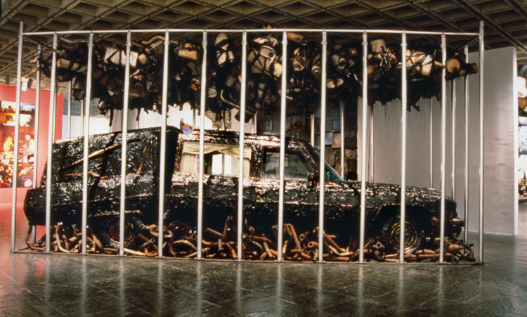 Nari Ward, Peace Keeper, 1995. Hearse, grease, muﬄers, and feathers, 144 x 116 x 264 in (365.8 x 294.6 x 670.6 cm). Installation views: Whitney Museum of American Art, New York, 1995. Courtesy the artist, Lehmann Maupin, New York, Hong Kong, and Seoul, and Galleria Continua, San Gimignano, Beijing, Les Moulins, and Havana (page 234).
