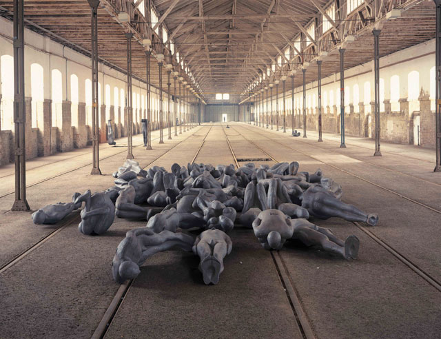 Antony Gormley. CRITICAL MASS II, 1995. 60 life-size elements, cast iron, dimensions variable. Installation view, StadtRaum Remise, Vienna, 1995. Photograph: Stephen White, London. © the artist.