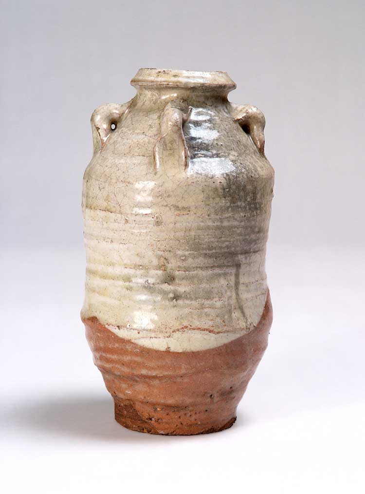Shōji Hamada, Earthenware bottle with four lug handles, c1920-23. Engobe and transparent glaze. Image courtesy of The Potteries Museum & Art Gallery, Stoke-on-Trent.