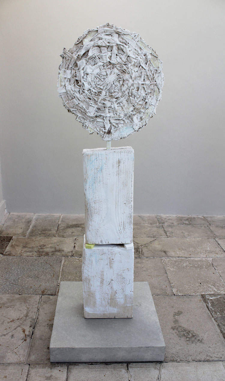 Jodie Carey. Sun Disc I, 2020. Colouring pencil, paint, earth, plaster, wooden shims, steel and concrete, 212 x 70 x 70cm. Copyright the artist.