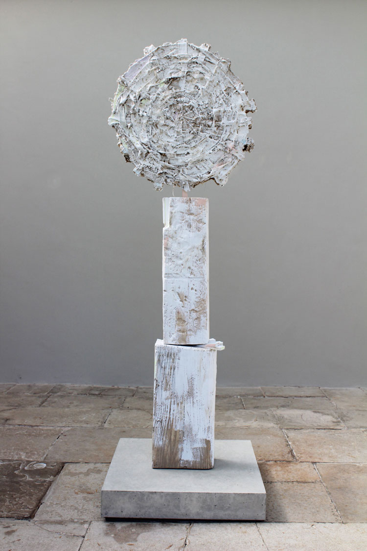 Jodie Carey. Sun Disc II, 2020. Colouring pencil, paint, earth, plaster, wooden shims, steel and concrete, 212 x 70 x 70cm. Copyright the artist.