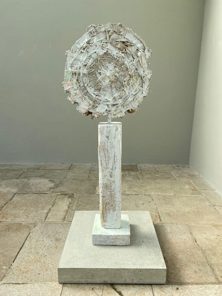Jodie Carey. Sun Disc II, 2020. Colouring pencil, paint, earth, plaster, wooden shims, steel and concrete, 164 x 70 x 70cm. Copyright the artist.