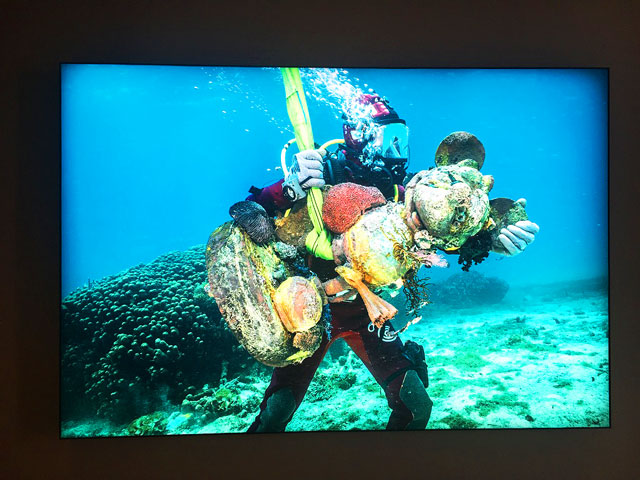 Damien Hirst. Mickey Carried by Diver. Powder-coated aluminium, printed polyester and acrylic lightbox, 152.8 x 299 x 10cm. Photograph: Joe Lloyd.