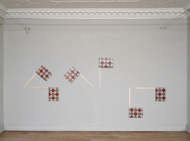 Nicky Hirst. All at Sea, 2017. Found linoleum on linen board, with wood, six pieces, each 40 × 91 cm. Semaphor flags spell out the letters WTF. Courtesy the artist and Domobaal. Photograph: Andy Keate.