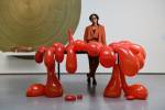 Anthea Hamilton poses in front of her work Vulcano Table, 2014. Photograph © Darren O’Brien/Guzelian. Courtesy The Hepworth Wakefield.