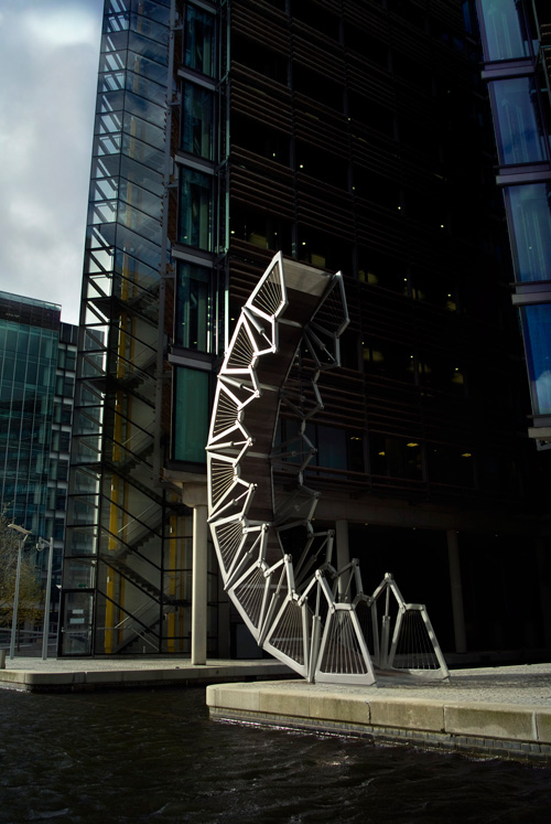 Heatherwick Studio. Rolling Bridge. Pedestrian bridge spanning an inlet of the Grand Union Canal at Paddington Basin, London. Photograph: Steve Speller.