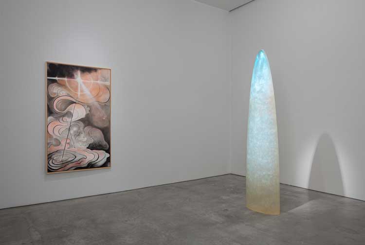 Left to right: Yulia Pinkusevich. Sakha Air Spirit, 2021. Pastel and charcoal on Fabriano Artistico paper over birch ply panel, 74 × 44 1/4 in (188 × 112.4 cm); Gisela Colón. Parabolic Monolith (Perseus), 2022. Aurora particles, stardust, cosmic radiation, intergalactic matter, ionic waves, organic carbamate, gravity and time, 98 1/2 × 23 1/2 × 12 in (250.2 × 59.7 × 30.5 cm). Installation view, Marlborough Gallery, New York. Photo: Olympia Shannon.