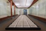 Xu Bing. Book of the Sky, c 1987–91. Installation of hand-printed books and ceiling and wall scrolls printed from wood letterpress type; ink on paper, each book, open: 18 1/8 × 20 in. (46 × 51 cm); three ceiling scrolls, each: 38 in. × approx. 114 ft. 9 7/8 in. (96.5 × 3500 cm); each wall scroll: 9 ft. 2 1/4 in. × 39 3/8 in. (280 × 100 cm). Lent by the artist. © Xu Bing.