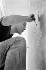 Robert Irwin in the studio working on an early line painting, 1962. © Marvin Silver/Courtesy of Marvin Silver and Craig Krull Gallery.