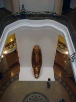 A visitor in the foyer of the CCBB Sao Paulo observes Anish Kapoor's Untitled at 'Ascension'. <em>Untitled</em>, 1999, brass, 445 x 124 x 108 cm