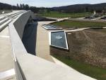 Up on the rooftop walkway, you can see the way the building nestles into the hill, opening out onto the town.