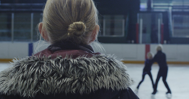 Liz Magic Laser. Kiss and Cry, 2015. Single-channel 4K video, 13 min 30 sec, video still (1). Featuring figure skaters Anna MacKenzie and Axel MacKenzie and coach Marie Jonsson MacKenzie. Commissioned and produced by Mercer Union.