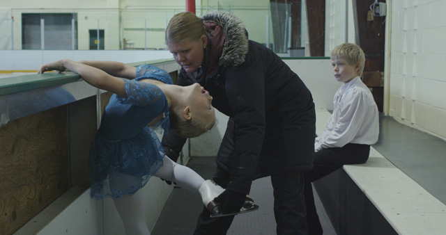 Liz Magic Laser. Kiss and Cry, 2015. Single-channel 4K video, 13 min 30 sec, video still (3). Featuring figure skaters Anna MacKenzie and Axel MacKenzie and coach Marie Jonsson MacKenzie. Commissioned and produced by Mercer Union.