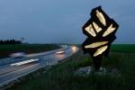 Bernard Lassus. Night photograph of motorway with sculpture.