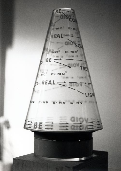 Liliane Lijn. E=MC3 Poemcon, 1968. Letraset on Perspex cone, motorised turntable, 44 x 23.5 x 23.5 cm. Text collaboration between Liliane Lijn and Nazli Nour. Collection the artist. Photograph: Liliane Lijn.