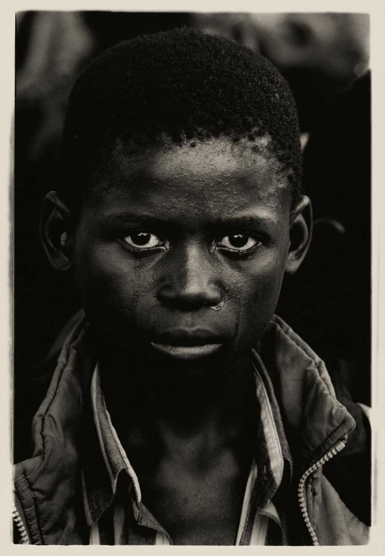 Don McCullin, A 15 year old boy crying at his father’s funeral, who died of Aids, Ndola cemetery, Zambia, 2000. © Don McCullin. Courtesy the artist and Hauser & Wirth.