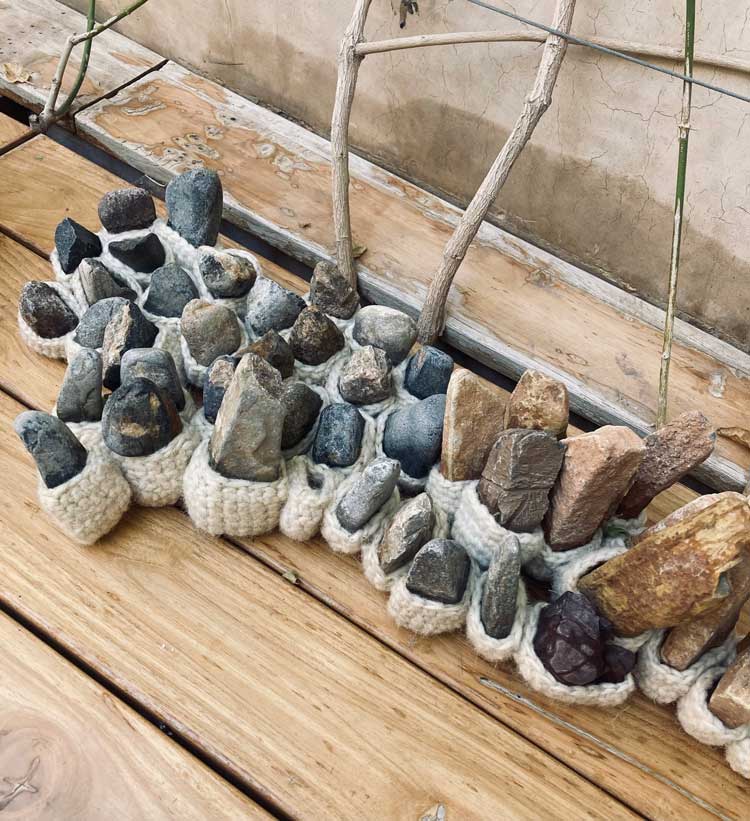Amina Agueznay. Reg, 2024 (detail). Installation, Natural undyed wool, stones from Souss Massa, cotton thread. Hand crochet and sewing, variable dimensions. Photo: Allie Biswas.