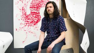 His work has included lighting 1,000 candles and getting two horses to pull a car. Now, he is using his dismantled childhood bed in one show and dancing in overalls laden with coins in another. He explains his interest in blurring the boundaries between media, and what attracts him to performance art