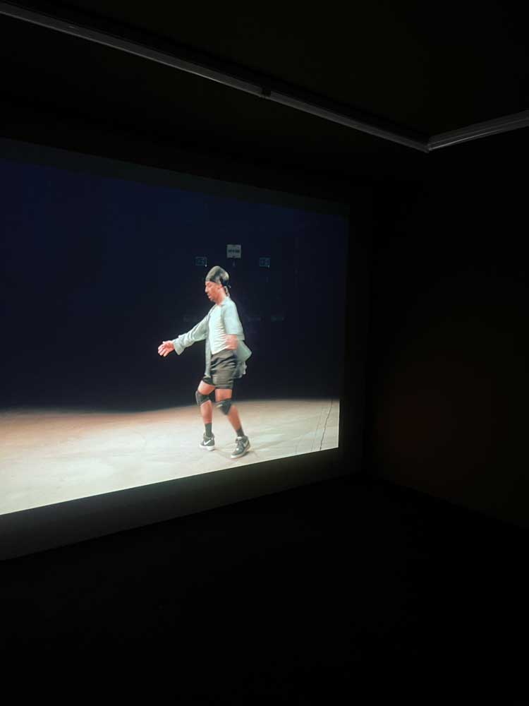 Paul Maheke. Scene from the filmed performance of Taboo Durag, 2021. Installation view, To be Blindly Hopeful, Mostyn Gallery, Llandudno, 2024. Photo: Veronica Simpson.