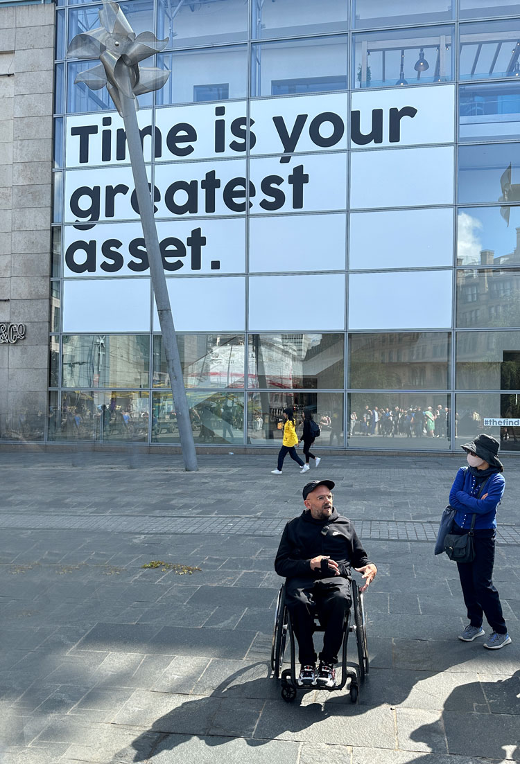 Ryan Gander in front of 'Time is your greatest asset', Selfridges department store, Exchange Square, Manchester International Festival 2023. Photo: Martin Kennedy.