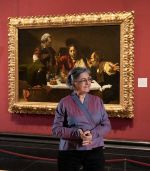 Nalini Malani in front of Caravaggio’s The Supper at Emmaus at the National Gallery. Photo © The National Gallery, London.