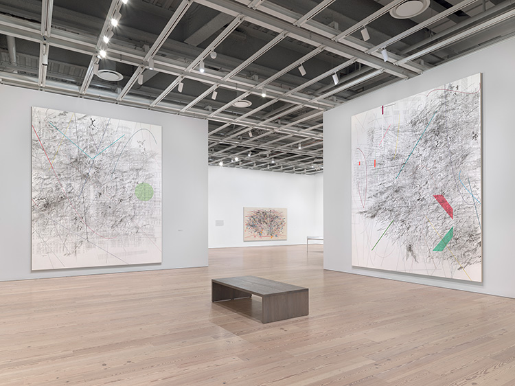 Installation view of Julie Mehretu (Whitney Museum of American Art, New York, March 24-August 8, 2021). From left to right: Mogamma (A Painting in Four Parts) Part 4, 2012; Renegade Delirium, 2002; Mogamma (A Painting in Four Parts) Part 1, 2012. Photo: Ron Amstutz.