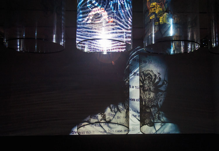 Nalini Malani, In Search of Vanished Blood, 2012. Six channel video/shadow play with five reverse painted Mylar cylinders, sound, 11 minutes. Installation view: Nalini Malani: In Search of Vanished Blood, ICA Boston, 2015. Collection: Guggenheim Abu Dhabi. Photo: Danita Jo. © Nalini Malani.
