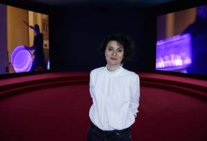 Portrait of Angelica Mesiti in her exhibition ASSEMBLY, 2019. Commissioned by the Australia Council for the Arts on the occasion of the 58th International Art
Exhibition – La Biennale di Venezia, courtesy of the artist and Anna Schwartz Gallery, Australia and Galerie Allen, Paris. Photography: Zan Wimberley.