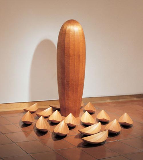 Donald Fortescue. <em>Self-Contained</em>, 2000-2001. Laminated and coopered mahogany with pyrographed markings, Laminated and coopered mahogany (Pod): 80 x 23 x 23in. (203.2 x 58.4 x 58.4cm) (Hulls): 5 1/2 x 27 x 9 1/2in. (14 x 68.6 x 24.1cm) each. Overall: Variable Dimensions. Museum of Arts & Design, New York. Museum purchase with funds provided by Simon Blattner, Marcia Docter, The Horace W. Goldsmith Foundation and The Wornick Family Foundation, 2005. Photo credit: Jeff Sturges, 2006.