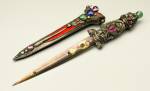 Marie Zimmermann. Dagger and Scabbard, dated 1921. Dagger handle: silver, emerald, pink tourmalines, jade, pink sapphire, ruby, emerald, blue sapphire, citrine, garnet, chrysoberyl, unheated multi-colored corundum. Blade: damascened steel with gold, pink tourmaline, blue sapphire, jade or chrysoprase, garnet, blue sapphire. Scabbard: silver, bone, red velvet, amethyst, lapis lazuli, pink tourmaline or pink sapphire, ruby or garnet, chrysoberyl, emerald, jade. Dagger, 8 1/2 in. (21.6 cm); scabbard, 6 1/8 in (15.6 cm). Private collection. Photograph: David Cole © Svartvik Metalworks, Ltd. Used by permission.