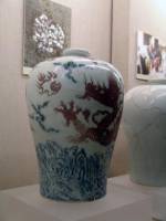 Blue and white and underglazed red cloud dragon design vase (Mei Ping). Ming dynasty Yongle (1403-24). Height: 34.1 cm. Diameter at mouth: 6.7 cm. Diameter at base: 15.9 cm. This vase (Mei Ping) has a very small mouth, short neck, wide shoulder and small base with a round rim. The mouth is so small that only a single stem of plum blossoms would fit inside. This type of porcelain has thus been named 'Mei Ping', or 'plum-blossom vase'. In fact, vessels of this type were wine containers and very popular during the Ming and Qing dynasties. The design of this vase is uniquely done with blue and white mountains and waves in the lower part, an underglazed red dragon on the main body and clouds on the shoulders.