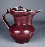Monk's cap-shaped pot with red glaze. Ming dynasty Yongle (1403-24). Height: 19 cm. Diameter at mouth: 11.2 cm. Diameter at base: 8 cm. The mouth of the jar seemed slightly like a cap of monk and so it was named. It is covered with red glazed but uneven.