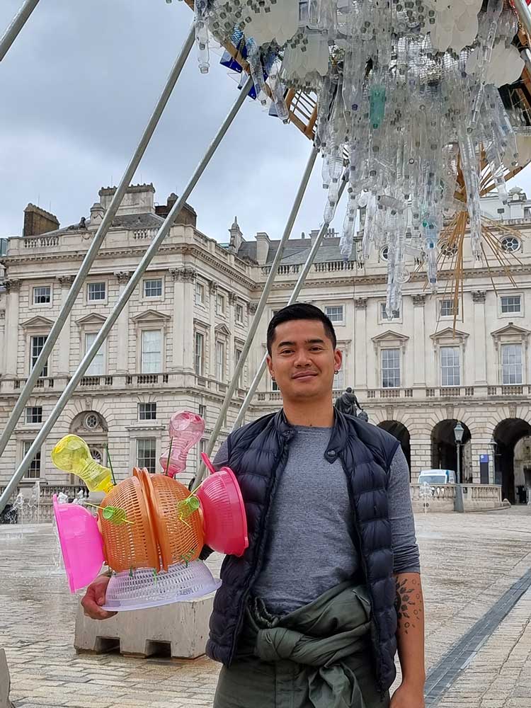 Leeroy New with junk space helmet with his installation The Arks of Gimokudan at Somerset House, London, 2022. Photo: Juliet Rix.