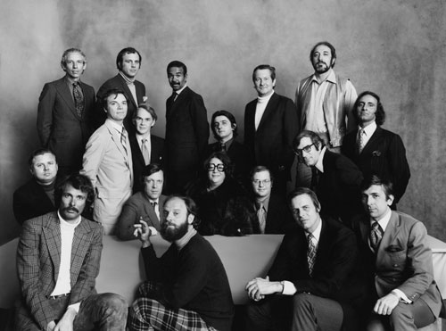 Regulars at the restaurant, Elaine's, in Manhattan, including, front row left to right: Arthur Kopit, Jack Gelber, George Plimpton and Gay Talese; second row, seated: Willie Morris, Jack Richardson, Elaine Kaufman, Christopher Cerf, David Halberstram; third row: Nicholas Pileggi, Robert Brown, Jean-Pierre Rassam (centre), and Bernard Farber (far right); back row: John Barry Ryan, III, Lewis H. Lapham, Bobby Short, William Styron, and Bruce Jay Friedman