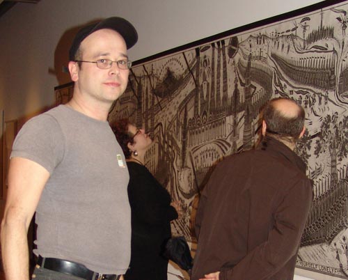 Chris Hipkiss in front of "Lonely Europe Arm Yourself," 1994 -1995, Pencil and ink on paper, 5 x 35'. Photo by Miguel Angel 