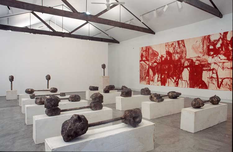 Mike Parr. ZIV (Mike Elephant Parr), ZIV, 235(h) x 614 (w) cm, 2001. Liftground aquatint from copper printed in red ink on 400gsm Hahnemuehle paper. Printer: John Loane. 14 bronzes on cast plaster plinths. Castings: Bruce Clayton. Photo: Fenn Hinchcliffe. Private collection.