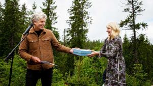 Future Library. Karl Ove Knausgård hands his manuscript to Katie Paterson, Nordmarka forest, Oslo, Norway. Photo: Kristin von Hirsch.