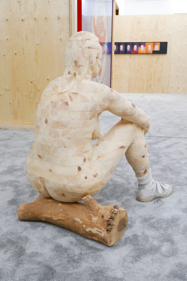 Maria Pasenau. Self-portrait With Graveyard Log, 1994-2019. Carved wood sculpture in pine, shoes and socks from the United States, and stump from Our Saviour cemetery. © the artist.