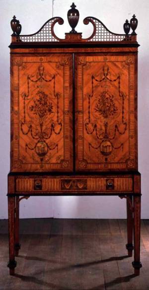 Ince and Mayhew Cabinet and stand, c.1775. Satinwood with marquetry in engraved, stained and shaded woods, the drawer fronts crossbanded with tulipwood and ebony mouldings 103 x 51 x 213 cm © 2003 Collection Lord Lloyd-Webber