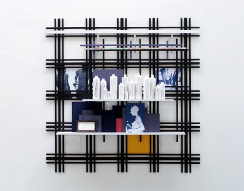 Remy Jungerman. Wise Words, 2010. Painted wood, textile, photo, gin-bottles, kaolin, framed tile, map, 67.72 x 68.11 x 9.05 in. Courtesy the artist.