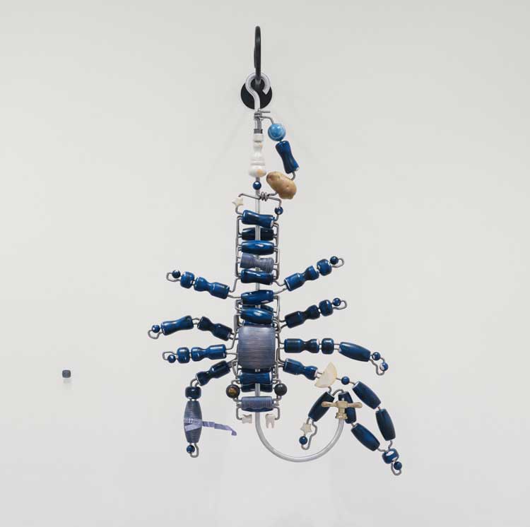 Magali Reus, Rig (Bisous Bisque), 2026. Painted, sanded, polished and waxed polyester; forged, brushed, blackened and oiled steel bar; forged, brushed and oiled aluminium bar; shaped, stained, sanded and wax-polished layered plywood; forged, sand-blasted and oiled stainless steel bar; polished graphite-coated polyester; sand-blasted, hand-manipulated, powder-coated and sprayed aluminium foil; brushed, sand-cast brass; shaped and polished Tiger Eye stone, powder-coated rivets. 167 x 93.5 x 49.5 cm. The Alexander Collection, London Installation view at The Perimeter. © Magali Reus. All works courtesy of the Artist, The Approach, London; Tanya Bonakdar Gallery, NYC, USA; Galerie Greta Meert, Brussels; Mai 36 Galerie, Zurich. Photo: Eva Herzog.