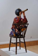 Yinka Shonibare RA. Cheeky Little Astronomer, 2013. Fibreglass mannequin, Dutch wax-printed cotton textile, leather, resin, chair, globe and telescope, 123 x 47 x 90 cm. Lent by the Royal Academy of Arts, London.